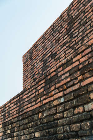 old brick wall and cloudy sky with selective focusの写真素材