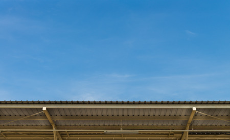 The blue sky with Metal sheet roofの写真素材