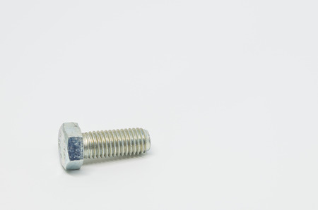 Stainless steel bolt on white background and selective focus