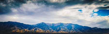 Beautiful Blue rocky canyon mountain landscape with cloudy sky in panorama viewの写真素材