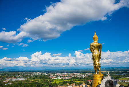 Stand Buddha statue with city view in Wat Phra That Kao Noi Nan Thailandの写真素材