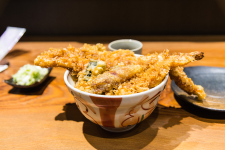 Delicious Seafood tempura tendon Japanese deep fried shrimp fish vegetables on rice with sweet sauce in the bowlの写真素材