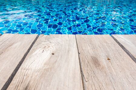 Blue ceramic floor in swimming pool with wooden floor in background conceptの写真素材