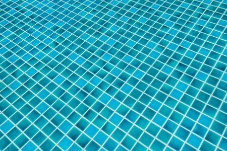 Blue ceramic pattern floor in Swimming pool for background conceptの写真素材