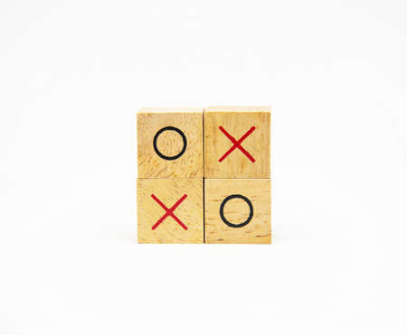 Two layer of wooden square block with O and X character symbol isolated on white background for design conceptの写真素材