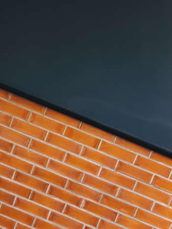 Orange brick wall in perspective view with black color wall for background wallpaper concept design