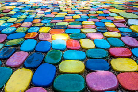Art colorful pattern stone of footpath walkway outdoor in the garden with exterior design concept ideaの写真素材