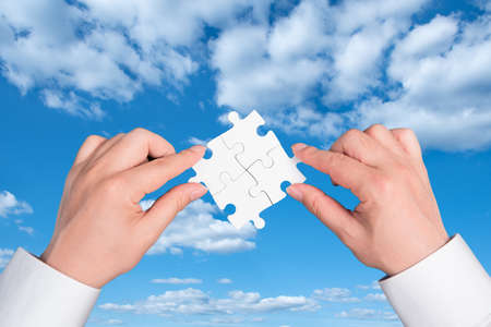 two hand holding connecting piece jigsaw puzzle, Business connection, success and strategy concept.の写真素材