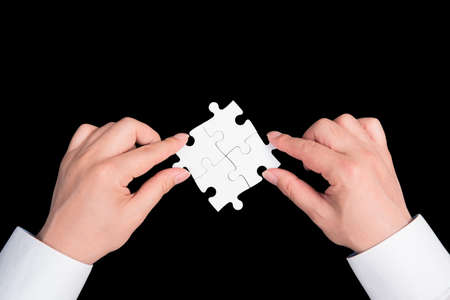 two hand holding connecting piece jigsaw puzzle, Business connection, success and strategy concept.の写真素材