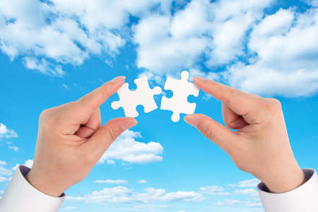 two hand holding connecting piece jigsaw puzzle, Business connection, success and strategy concept.の写真素材