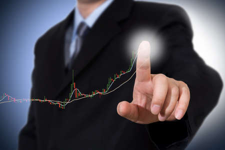 Businessman Touching a Graph Indicating Growthの写真素材