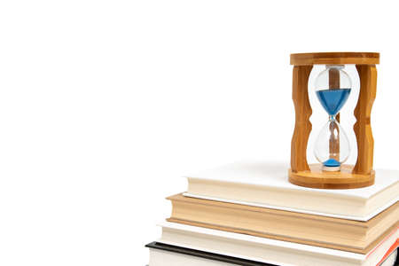 Hourglass and books isolated on white backgroundの写真素材