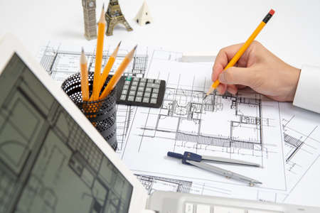 The hand of a male architect drawing a design using a pencil.の写真素材