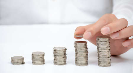 Hand of a business man pile up coins. Financial Concept.の写真素材