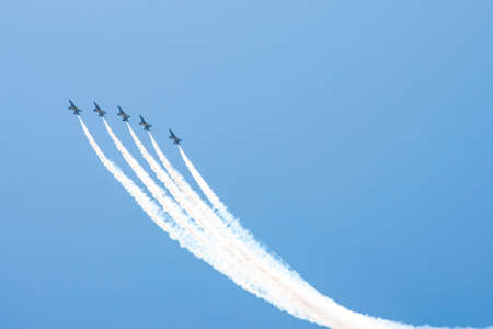 Airplane trails on blue sky with copy spaceの写真素材