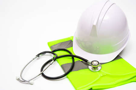 On a white background, there are safety hats, work clothes, and stethoscopes.の写真素材