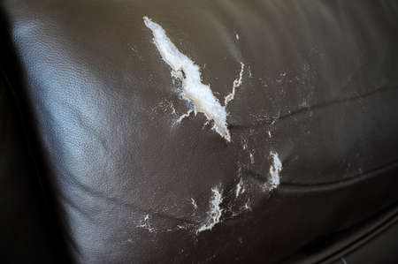 Old leather cover, torn leather cover, damaged leather sofa.の写真素材