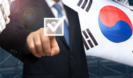 South Korea election concept. A businessman's election campaign against the backdrop of a Korean flagの写真素材