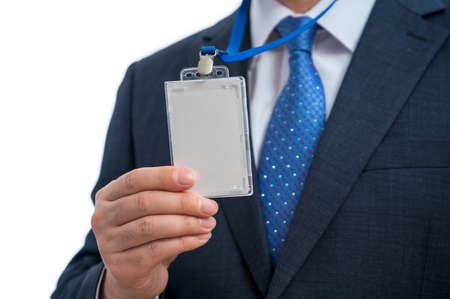 Businessman in suit wearing a blank ID tag or name card on a lanyard at an exhibition or conferenceの写真素材