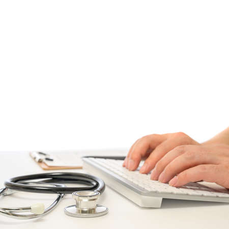 Hands of a male doctor who uses a computer keyboard.の写真素材