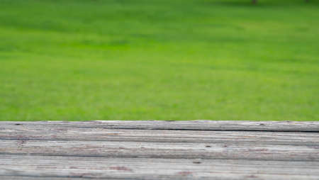 Wood deck and blur nature green grass background.の写真素材