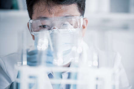 Asian male scientist working in a laboratory. Vaccine development concept.の写真素材