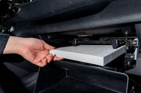 Changing the air filter inside the car. car maintenanceの写真素材