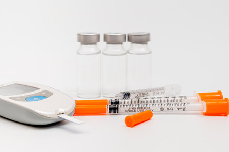 Glucometer and insulin syringe, lancing device tester strip. On white background.の写真素材