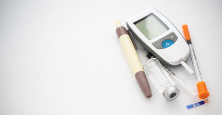 Glucometer and insulin syringe, lancing device tester strip. On white background.の写真素材