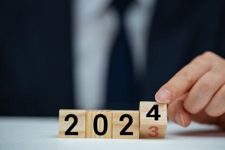 Flipping of 2023 to 2024 on flip block for preparation new year change and start new business target strategy concept.の写真素材