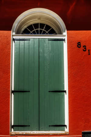 New Orleans LA USA -  Sep. 13, 2016  - Image is of a Green Door or Shutters on a Red Building in the French Quarter of New Orleansのeditorial素材