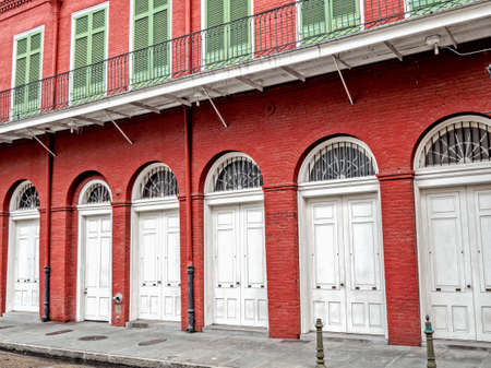 New Orleans, LA, USA -  Sep. 12, 2016  -  Red Building with White Doors and Green Shutters in the French Quarter in New Orleansのeditorial素材