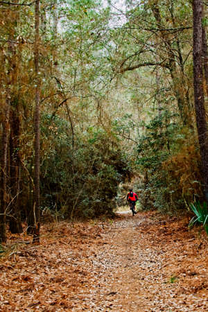 The Woodlands TX USA - 01-09-2020  -  Bike Rider with Red Jacket in Woodsのeditorial素材