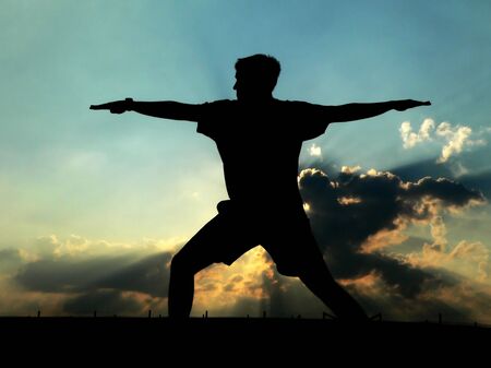 Silhouette of Man Practicing Yogaの写真素材