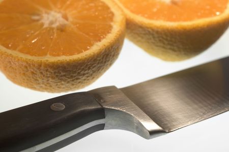 closeup of sliced orange and knife on white backgroundの写真素材