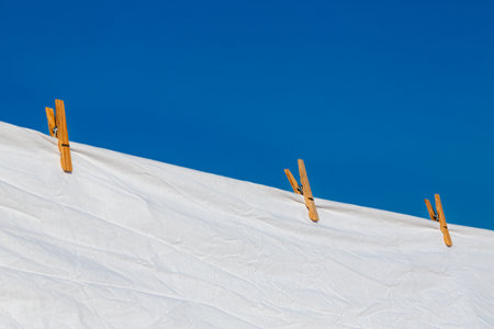 Murcia, Spain - 12th August 2024 - White laundry drying in sunlight against a clear blue sky, creating a vibrant atmosphere during a summer dayの写真素材
