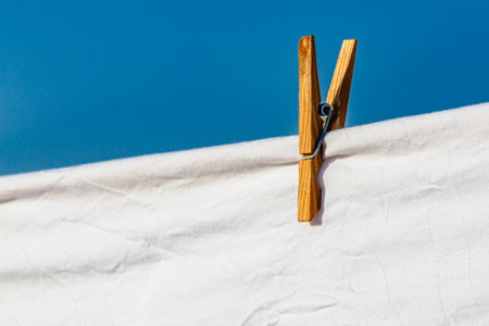Murcia, Spain - 12th August 2024 - White laundry drying in sunlight against a clear blue sky, creating a vibrant atmosphere during a summer dayの写真素材