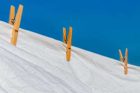 Murcia, Spain - 12th August 2024 - White laundry drying in sunlight against a clear blue sky, creating a vibrant atmosphere during a summer dayの写真素材