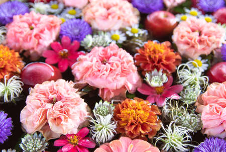 Flower arrangement of apples and pink flowersの写真素材
