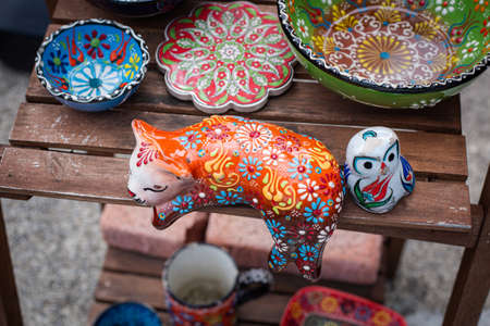Colorful ceramic cat figurines and bowlsの写真素材
