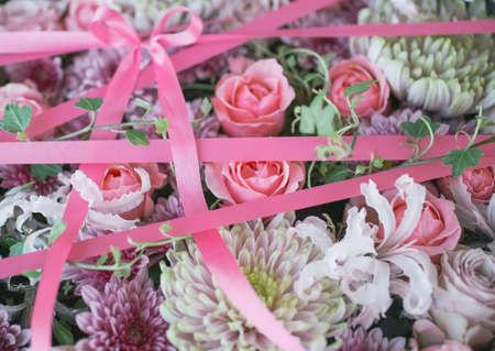 Floral background with pink ribbon.の写真素材