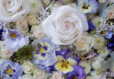 Flower arrangement of violas and rosesの写真素材