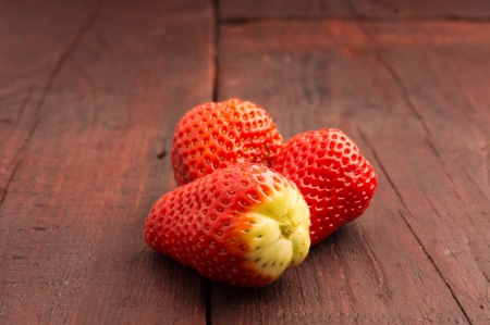 fresh strawberries scattered on the old planksの写真素材