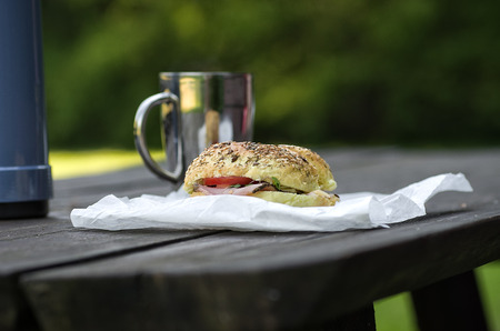Breakfast in the park, thermos, sandwich and cupの写真素材