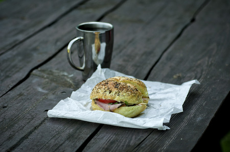 Breakfast in the park, thermos, sandwich and cupの写真素材