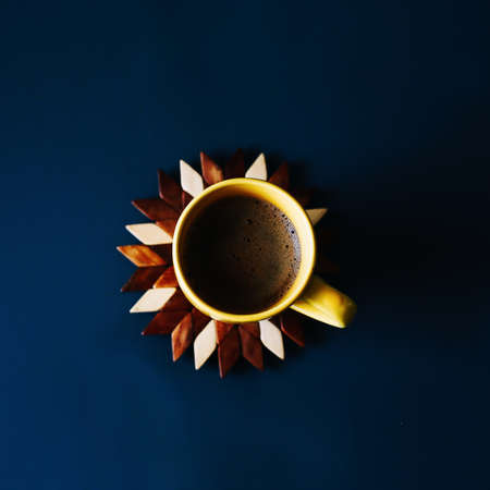 A cup of coffee on a blue backgroundの写真素材
