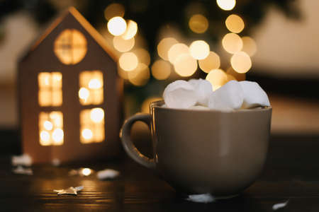 Christmas coffee cup with marshmallows. Still life on dark background. New Year's lights and decorations. Flat layの写真素材