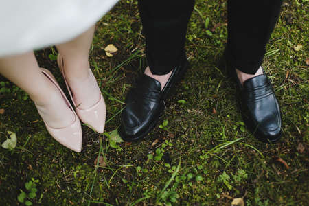 Bridal and groom wedding shoes on the background of green grass. wedding detailsの写真素材