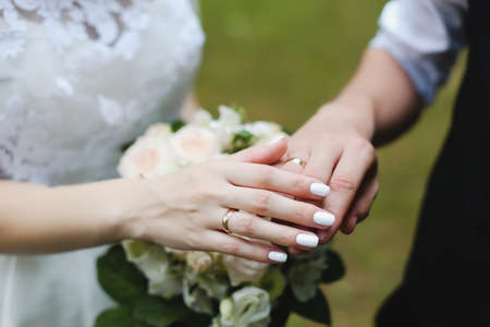 Hands of groom and bride with rings.  wedding detailsの写真素材