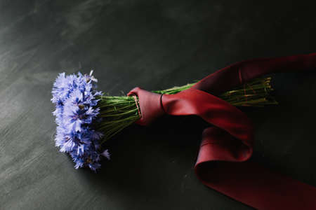 bouquet of cornflowers on a dark background. wedding details, bridal bouquet. wild flowersの写真素材